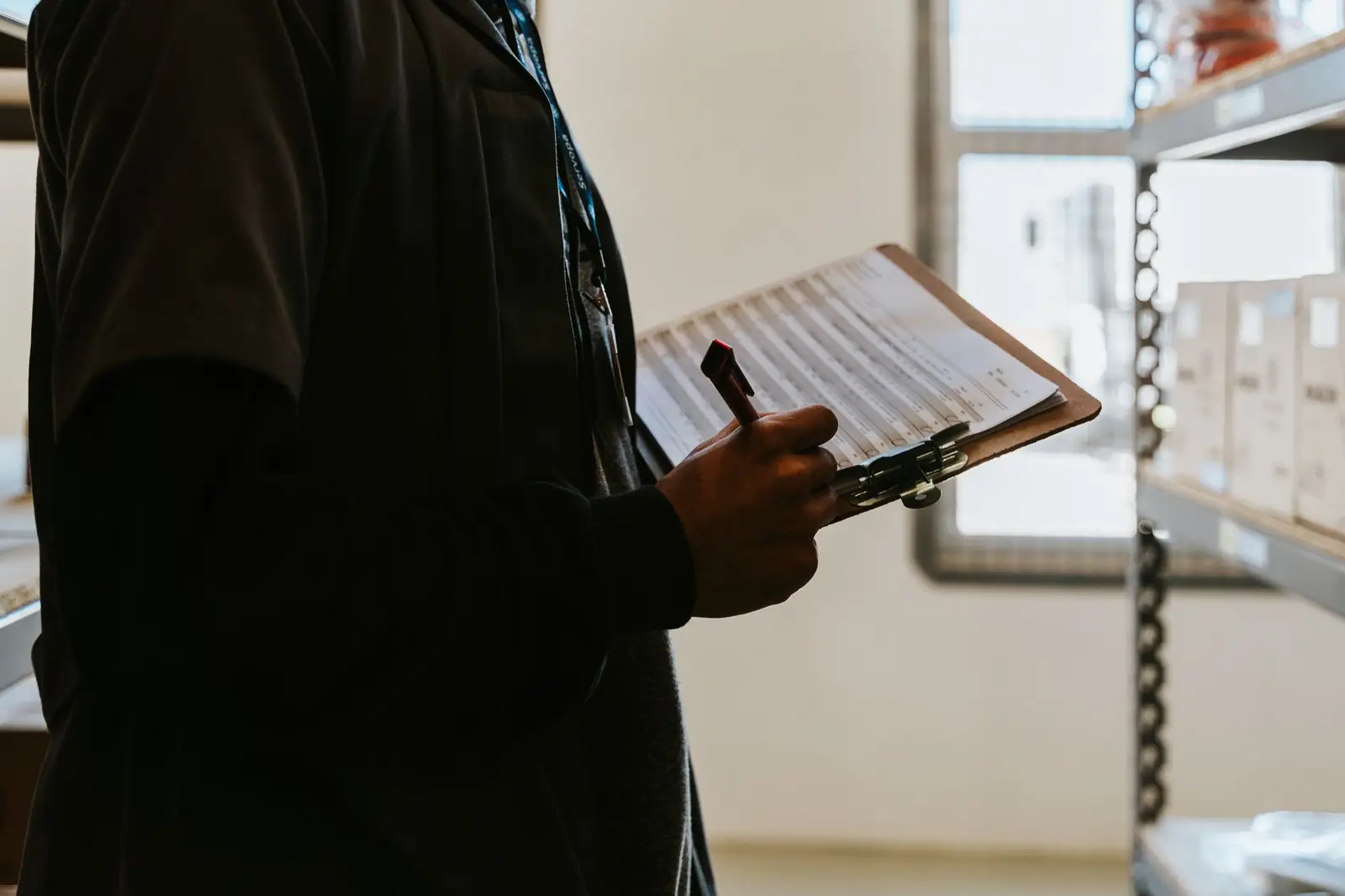 Auditor reviewing records on a clipboard