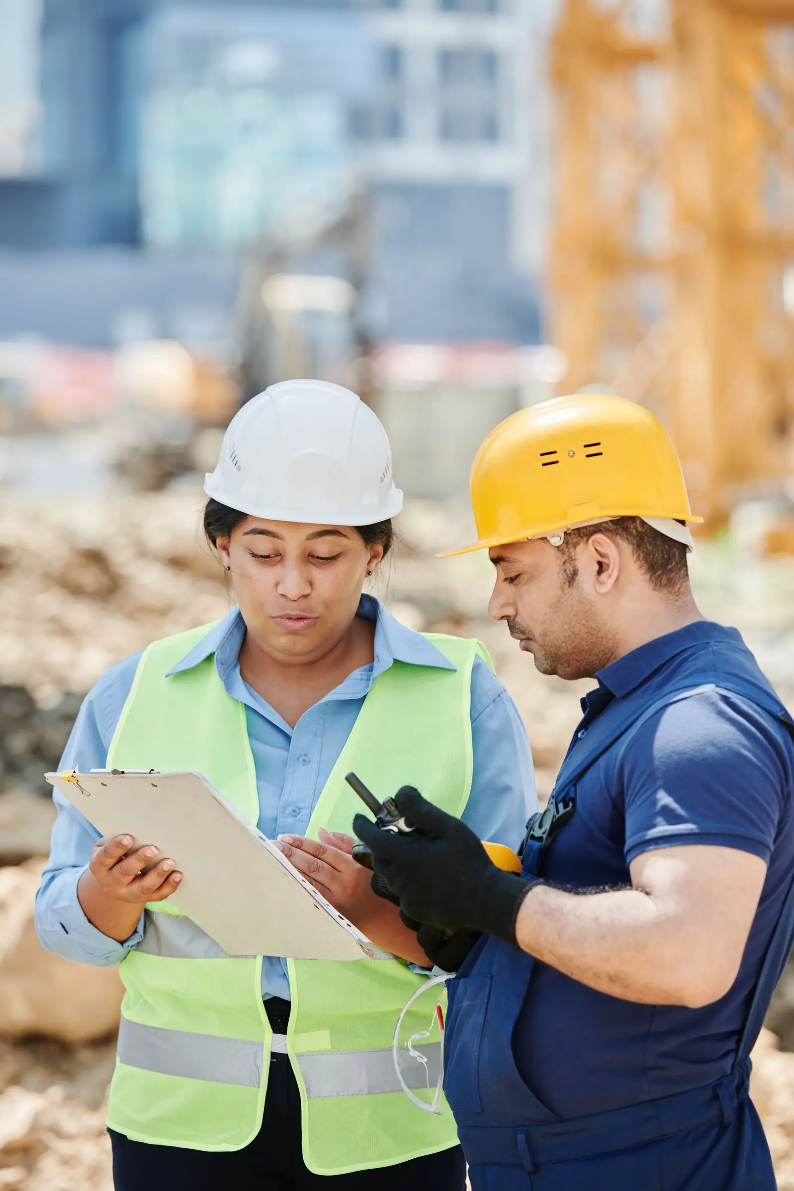 Site team in hard hats reviewing a safety checklist