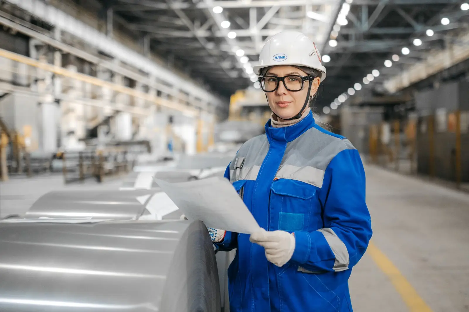 ISO consultant reviewing audit documents on a factory floor
